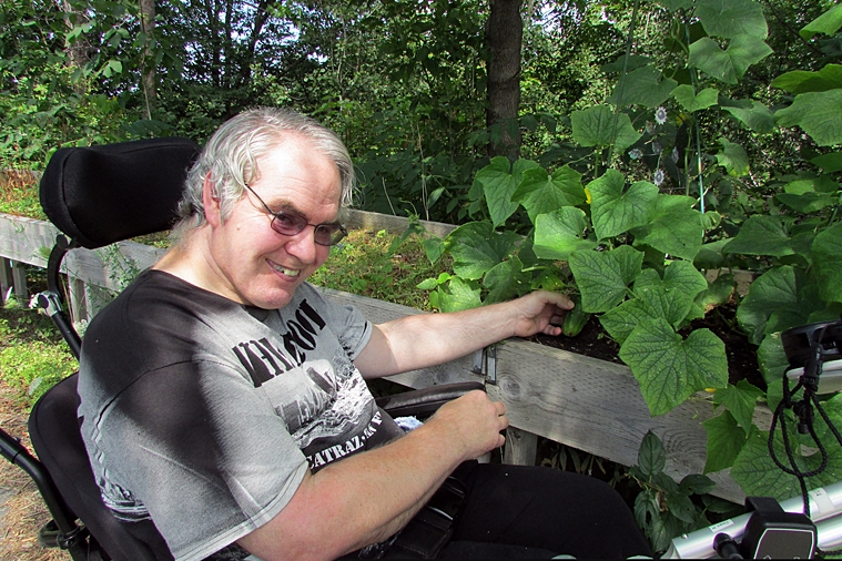 Dean enjoying his crops at Forest Hill Garden